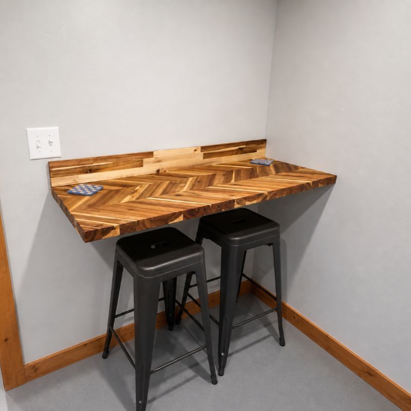 Modern kitchen dining area featuring a butcher block counter and barstools in the Black Hills, SD.